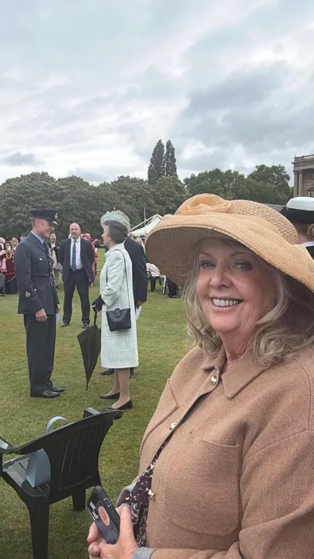 June Field at a Buckingham Palace garden party, with Princess Anne behind her