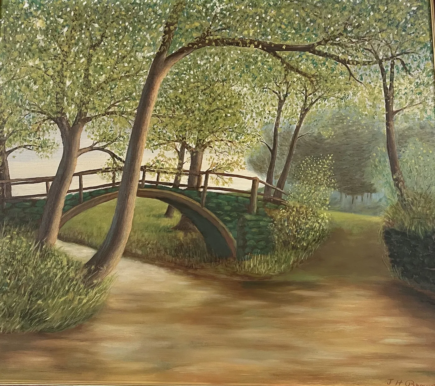 The bridge from her dad's painting: a wooden footbridge over a stream, framed by trees