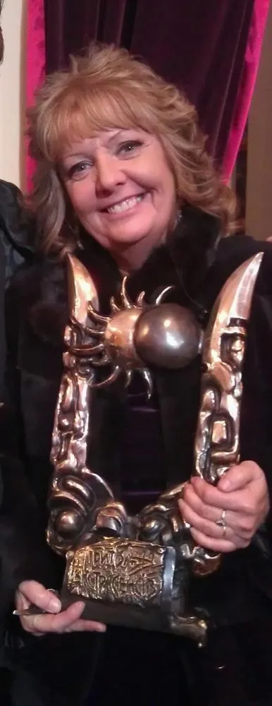 June Field holding the International Battle of the Psychics trophy
