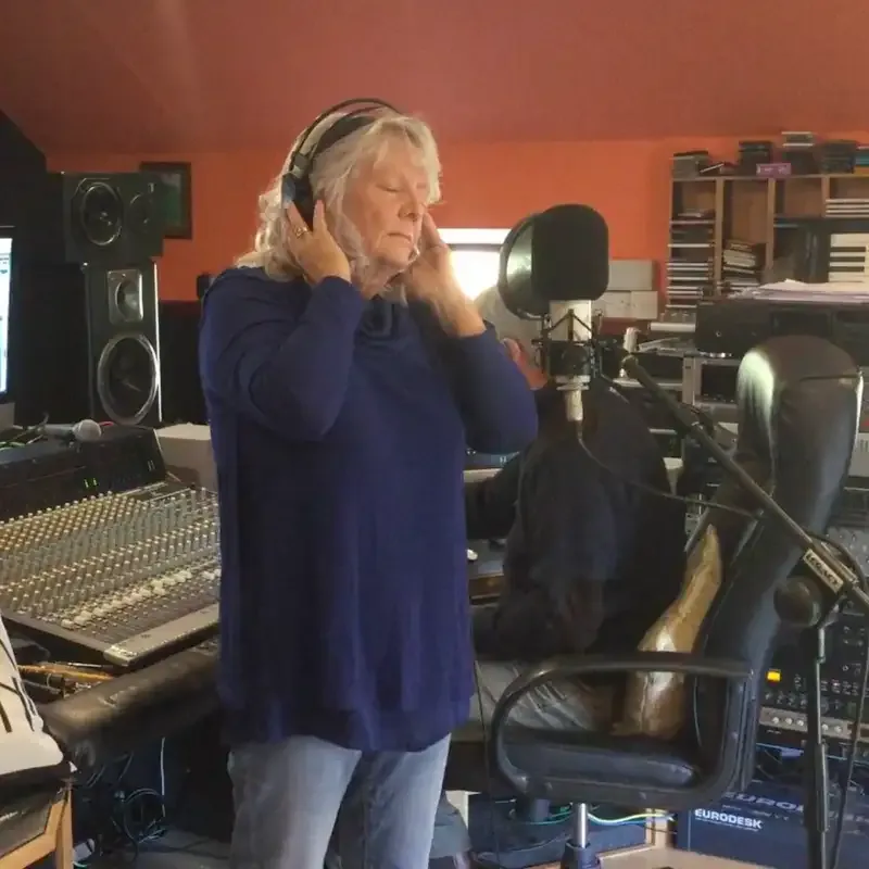 June Field singing in a recording studio